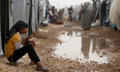 A file picture dated 11 October 2014 shows a Syrian refugee girl sitting in front of a tent in a refugee camp after she fled from Islamic State violence at Suruc district, Sanliurfa, Turkey.