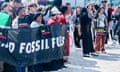 Protesters outside the World Conference Center in Bonn with a banner against Fossil fuels as well as pro-Palestinian banners