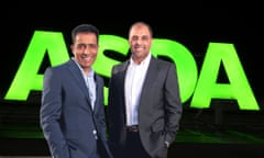 Mohsin and Zuber Issa, owners of the UK supermarket chain Asda, in front of a company logo