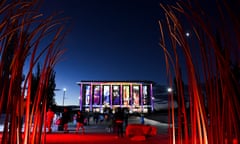The National Library in Canberra lit up by projections under an evening sky
