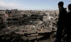 01/01 Palestinians look down on the rubble of the destroyed house of senior Hamas militant Nizar Rayan after an Israeli airstrike hit a nearby mosque in the Jebaliya refugee camp, northern Gaza Strip, Friday, Jan. 2, 2009. Israel showed no sign of slowing a blistering seven-day offensive against Hamas militants in Gaza, destroying homes of the group’s leaders and bombing one of its mosques a day after a deadly strike on a prominent Hamas figure killed him and most of his family. (AP Photo/Hatem Moussa)