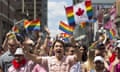 Prime Minister Justin Trudeau waves a flag as he takes part in the annual Pride Parade in Toronto on Sunday, July 3, 2016. (Mark Blinch/The Canadian Press via AP)