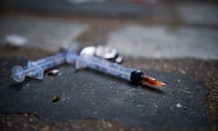  Needles are seen littering the pavement 
