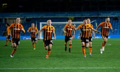 Hull players run towards the camera after Alfie Jones scored the winning penalty at Elland Road.