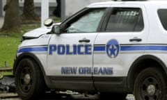 Investigators stand in front of a New Orleans Police department vehicle in which one officer was shot and killed while transporting a prisoner in New Orleans, Saturday, June 20, 2015. (AP Photo/Gerald Herbert)