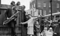 American teenage singer Brenda Lee rehearses for ITV's show Oh Boy in the streets of Islington, London, in 1959, accompanied by Benny Green on saxophone and watched by local children.