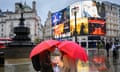 People with umbrellas in the wet weather in Piccadilly Circus, London, in 2023.