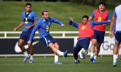 Harry Kane shoots under pressure from Jude Bellingham during a training session