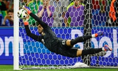 Diogo Costa saves a penalty by Slovenia's Jure Balkovec during the penalty shoot-out.