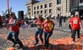 people in red t-shirts running away