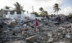 A girl walks past the cemetery in Jenrok village, on the Majuro atoll