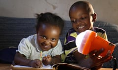 Two children with off-grid solar light