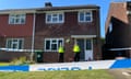 Officers stand outside a semi-detached house with a police cordon around it