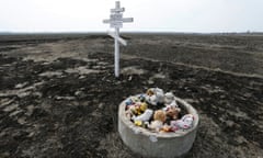 Toys near a cross in memory of victims of the MH17 plane crash in Rozsypne, Donetsk region, Ukraine.