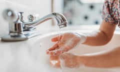 Close up view of young child washing hands with soap in sink