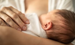 a mother breastfeeds her child