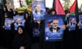 Anti-Israel demonstrators in Tehran hold portraits of the assassinated Hamas leader Ismail Haniyeh on 31 July 2024.