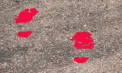 Footprints in red paint on a path