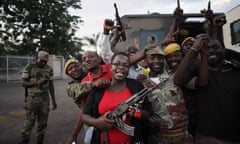 People and soldiers celebrate after the resignation of Zimbabwe’s president on November 21.
