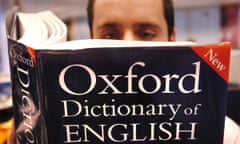 Seeking mansplanation … a man consults the Oxford Dictionary of English.