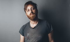 dan auerbach standing in a faded t shirt