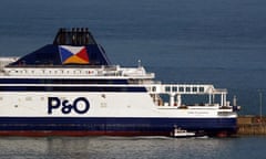 A white ferry with the P&O branding on the side in blue, moored at a harbour