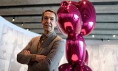 US artist Jeff Koons poses in front of his artwork titled ‘Balloon dog’ 
