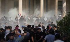 Iraqi security forces fire teargas during protests by supporters of the Shia cleric Muqtada al-Sadr inside the government palace in Baghdad