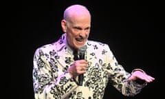 John Waters at the Barbican, in white jacket with black floral design