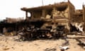 A damaged car and buildings at the central market in Khartoum.