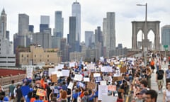 People walk across the Brooklyn Bridge as part of the March for Our Lives protest.