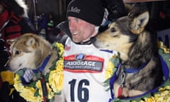 Dallas Seavey poses with his lead dogs Reef, left, and Tide after winning the Iditarod race