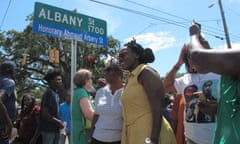 Woman in yellow dress under a street sign