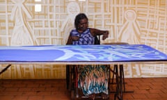 Dhambit Munuŋgurr painting in her signature palette at the Buku-Larrŋgay Mulka Centre in Yirrkala.