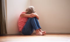 Unhappy girl sitting on the floor with her head in her hands.