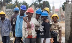 The image displays a cross-sectional view of female workers engaged in various construction tasks at the site. . - Maternal Center of Excellence located in the Kono region, Sierra Leone.