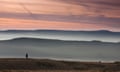 A man walking on Pendle hill in Lancashire