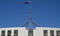 The coat of ams and the flagpole is seen at Australia’s Parliament House