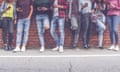 Group of eight teen friends millenials boys and girls watching smart mobile phones in front of brick wall background. Concept of youth, tech, social a<br>R5R6ME Group of eight teen friends millenials boys and girls watching smart mobile phones in front of brick wall background. Concept of youth, tech, social a