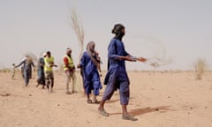 Members of the M’bera camp Anti-Fire Brigade walk in formation practising firefighting techniques.