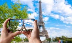 Tourist taking photo of Eiffel Tower in Paris.