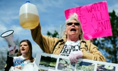 Gladyes Williamson holds up a discolored jug of water and chants along with other protestors outside the Farmers Market downtown on April 25, 2015, which marks the one year anniversary of the City of Flint switching from using Detroit water to Flint River water. Flint residents of all ages gathered outside Flint City Hall, located on S. Saginaw Street, with signs, t-shirts, and megaphones before walking throughout many streets downtown to voice their concerns with the public. (Sam Owens/The Flint Journal-MLive.com via AP)