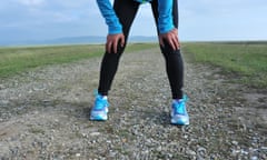 tired female runner taking a rest running hard in countryside