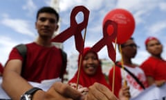Acehnese activists hold a HIV ribbon sign as they mark World Aids Day in Indonesia.