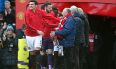 Manchester United’s Harry Maguire leads his team out and shakes hands with the ‘adult mascots’ outside the tunnel during the Premier League match against Watford at Old Trafford, Manchester.