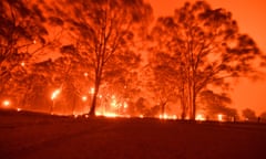 Glowing orange sky over burning forest in NSW