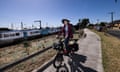 Nathan Mackie rides his ebike on the bike track next to Ruthven station