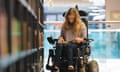 Young woman in a wheelchair in a library.