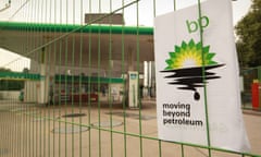 A Greenpeace poster displaying a leaking oil logo on closed a BP petrol station in Camden, London.