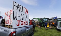 Farmers protesting with a sign that says "Fart tax, what a joke!"